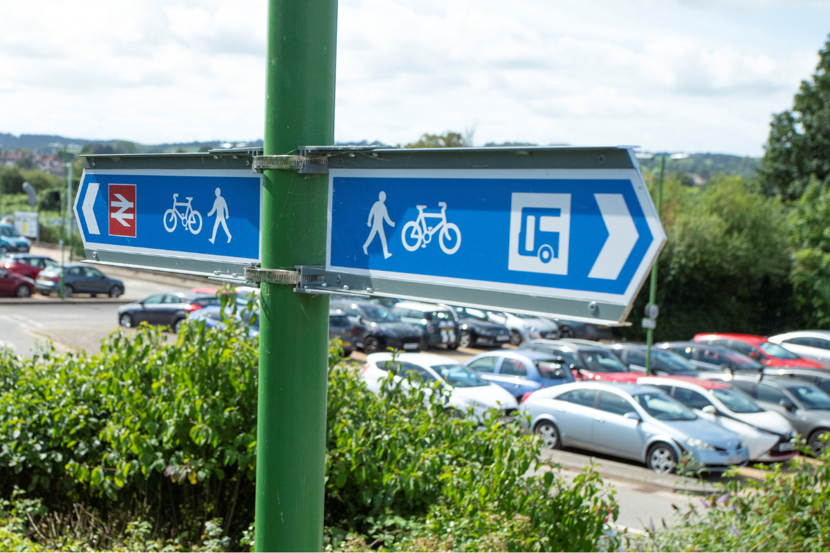 botm-featured A sign post pointing to a railway and a bus
