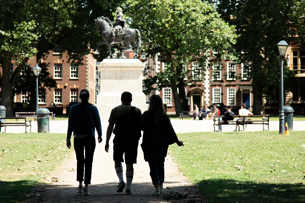 Switch the way you travel People walking across Queens Square on a sunny day