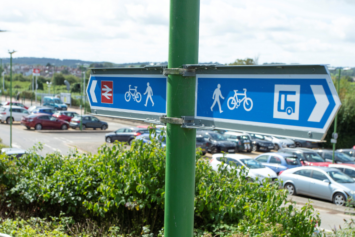 Sign pointing to railway station and bus stops